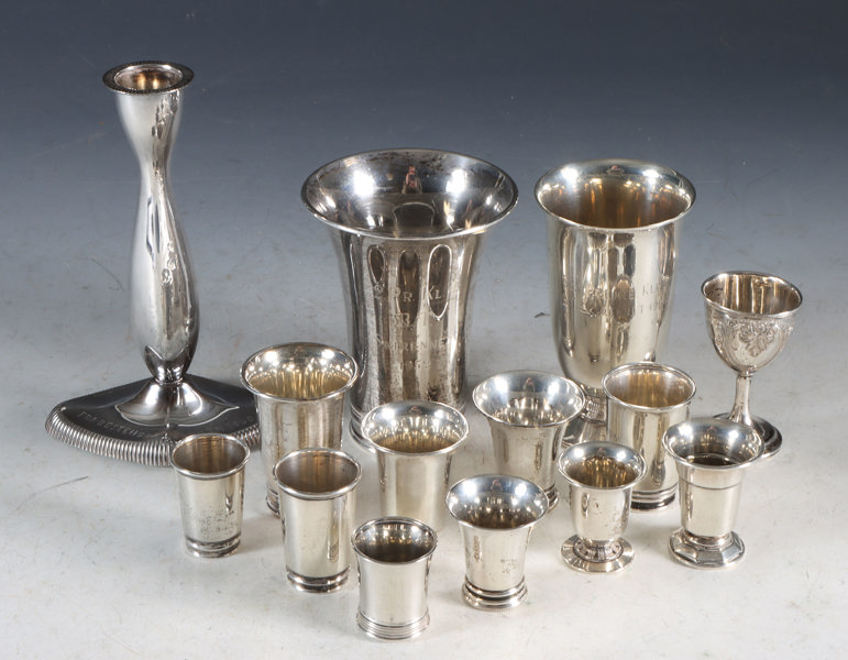 13 pokaler og lysestake med gravering. Sølv