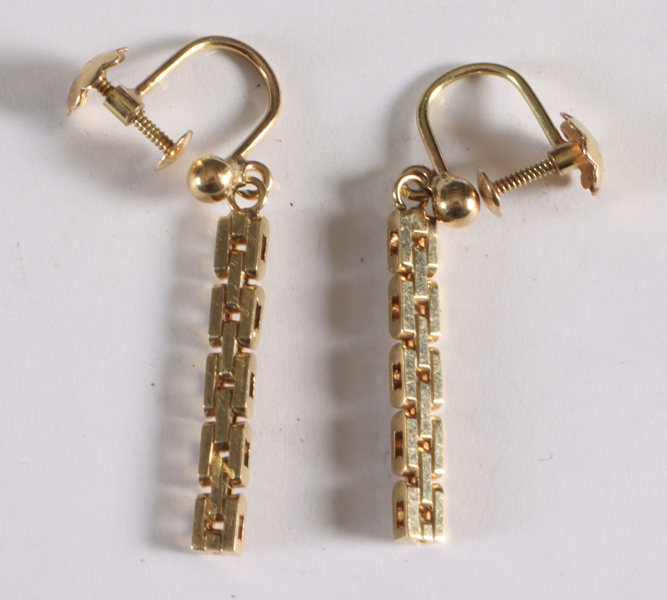 Et par ørepynt i gull.